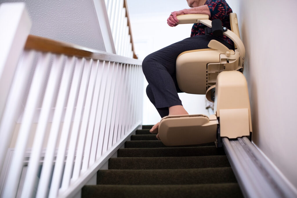 senior woman sitting on a stairlift