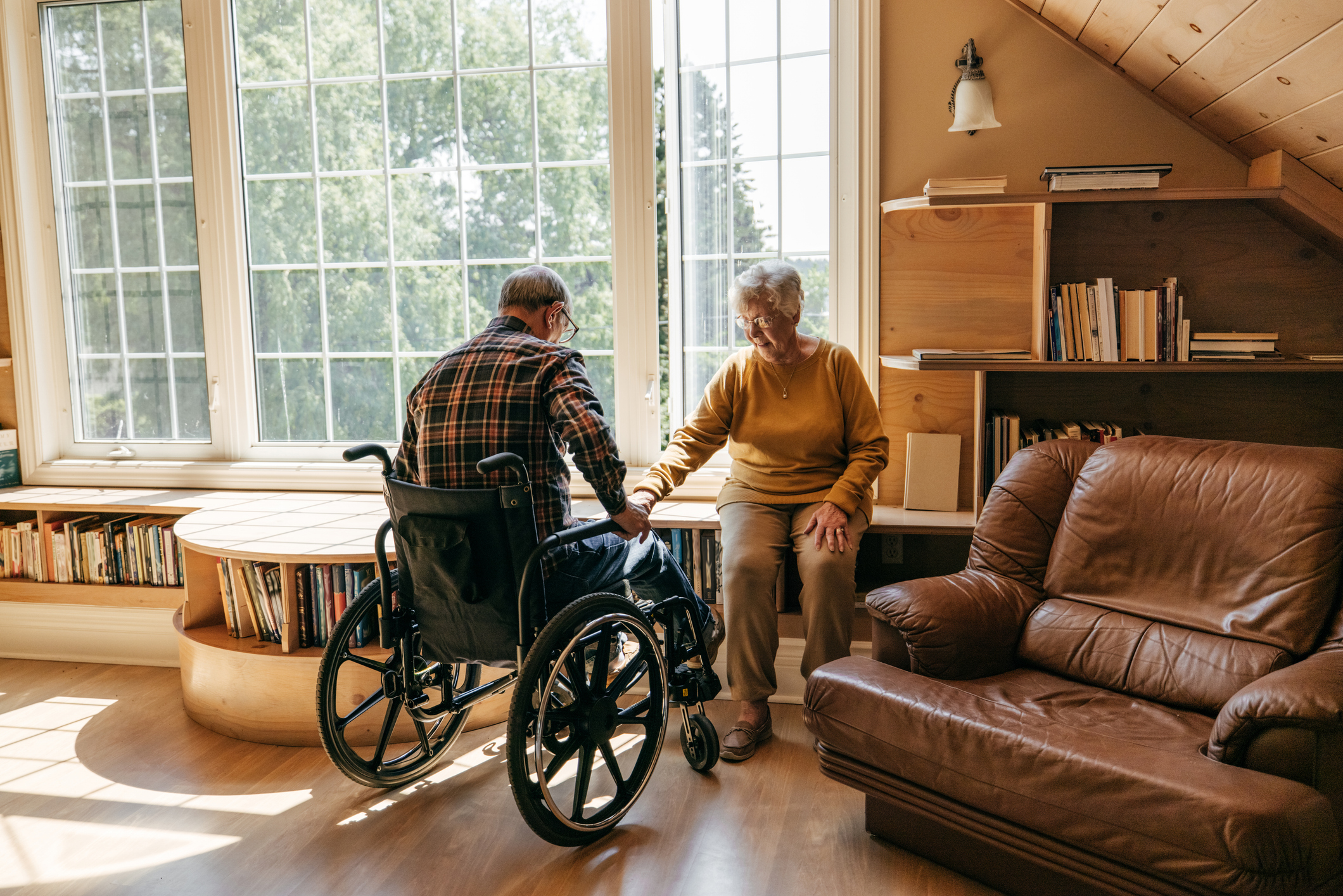 Husband on wheelchair talking to his wife