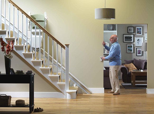 senior trying stairlift remote control