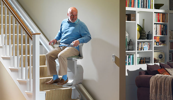 senior trying a straight stairlift