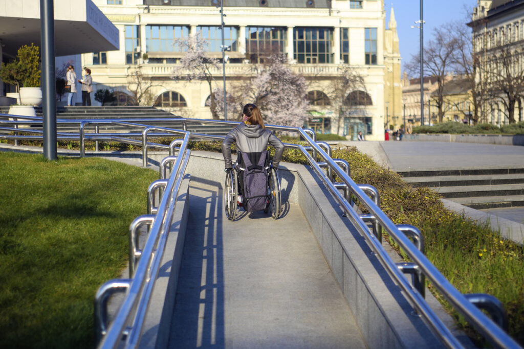 disabled young woman on a wheelchair in the city